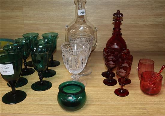 A set of six dark green wine glasses, a vine etched ruby glass decanter and five matching liqueur glasses, etc.